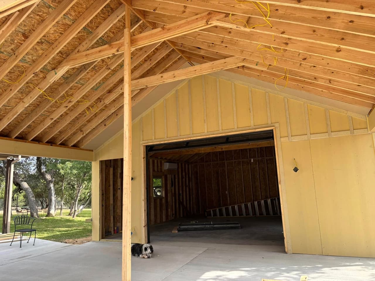 New construction rough-in electrical wiring in framing stage showing exposed beams and prewired circuits in Hood County Texas